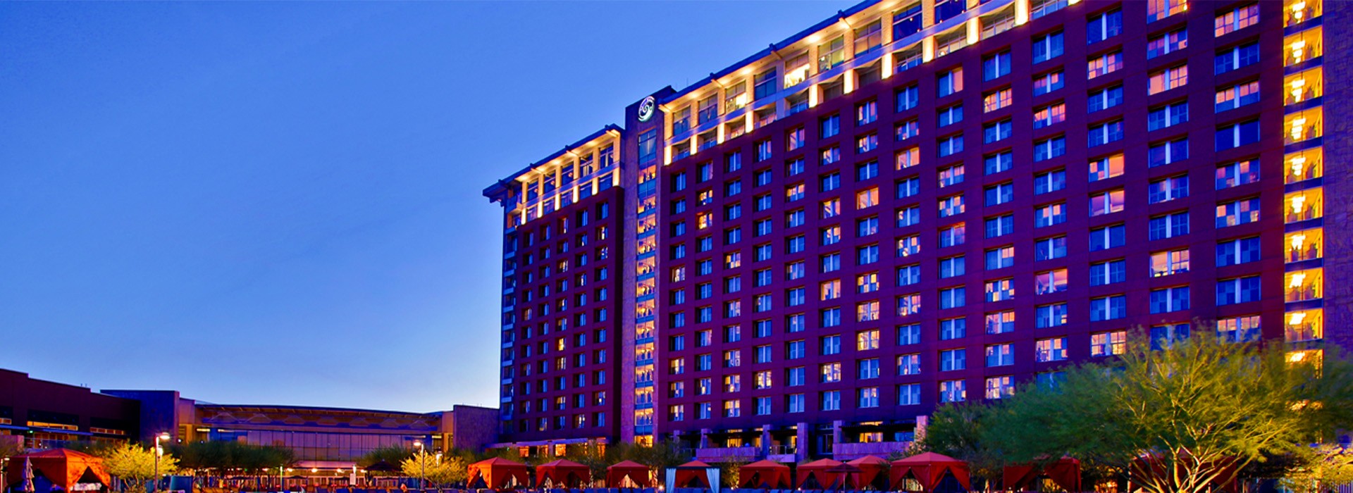 The profile of the Talking Stick Resort lit up purple at dusk in Salt River, Arizona.